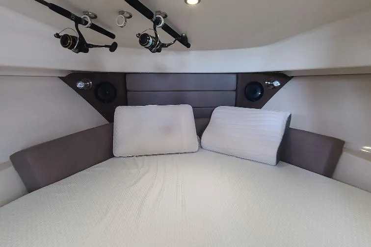 The Snapper Slapper Yacht Photos Pics Interior cabin of 2014 Boston Whaler 315 Conquest Pilothouse with fishing rods.