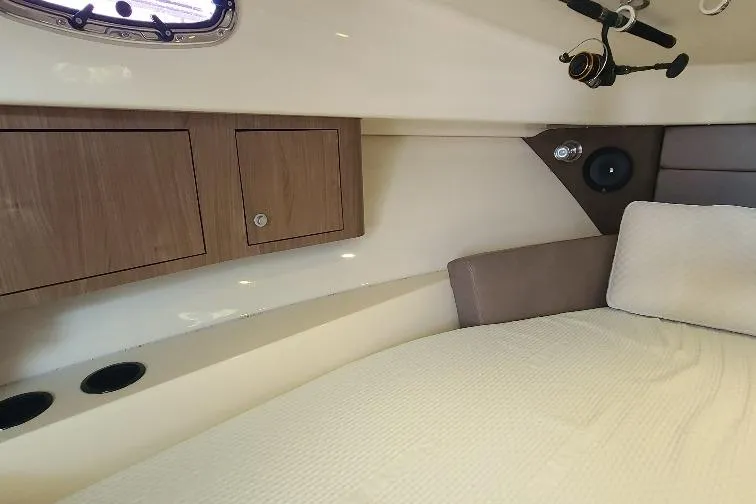 The Snapper Slapper Yacht Photos Pics Interior cabin of 2014 Boston Whaler 315 Conquest Pilothouse with bed and storage cabinets.