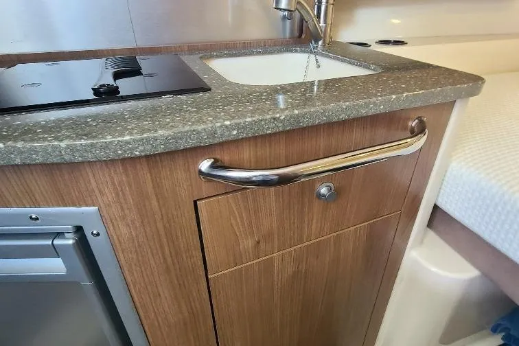 The Snapper Slapper Yacht Photos Pics Interior of 2014 Boston Whaler 315 Conquest Pilothouse with sink and countertop.