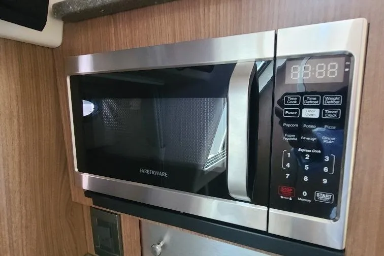 The Snapper Slapper Yacht Photos Pics Microwave in 2014 Boston Whaler 315 Conquest Pilothouse, featuring stainless steel design.