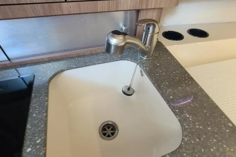 The Snapper Slapper Yacht Photos Pics Stainless steel sink and faucet in 2014 Boston Whaler 315 Conquest Pilothouse kitchen area.