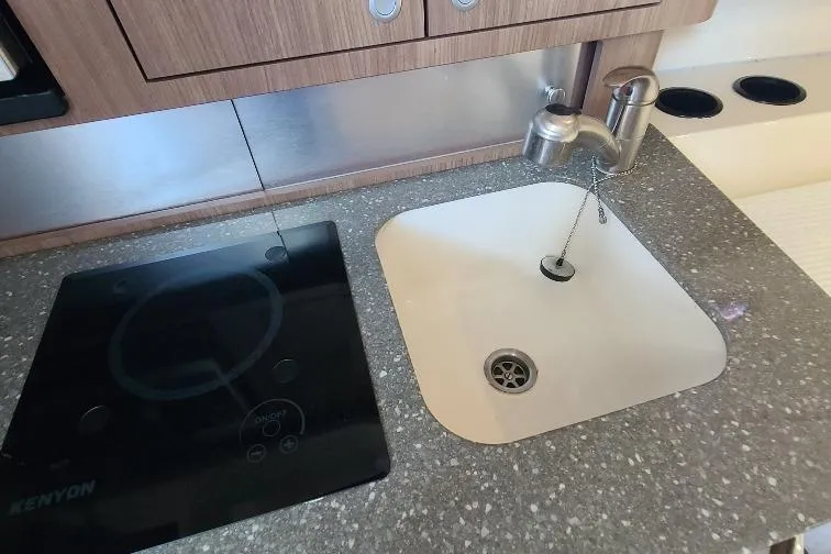 The Snapper Slapper Yacht Photos Pics Kitchen area of 2014 Boston Whaler 315 Conquest Pilothouse with sink and stove.