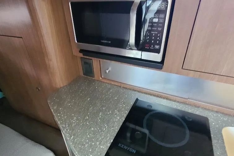 The Snapper Slapper Yacht Photos Pics 2014 Boston Whaler 315 Conquest Pilothouse kitchen with microwave and Kenyon cooktop.