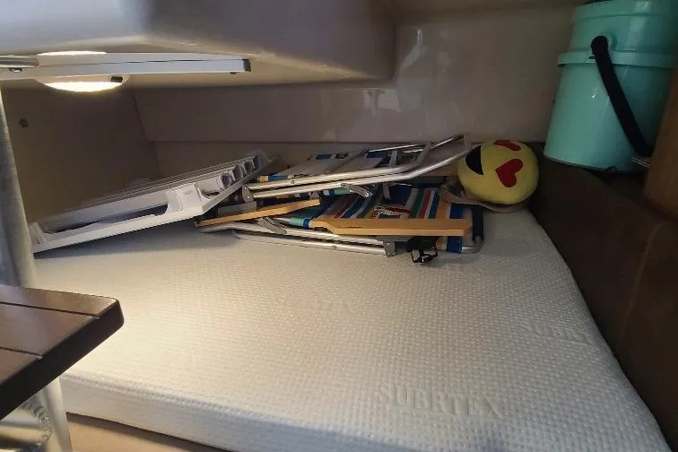 The Snapper Slapper Yacht Photos Pics Cabin interior of 2014 Boston Whaler 315 Conquest Pilothouse with beach chairs and emoji pillow.