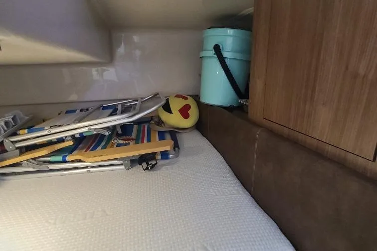 The Snapper Slapper Yacht Photos Pics Interior of 2014 Boston Whaler 315 Conquest Pilothouse with beach chairs and emoji pillow.