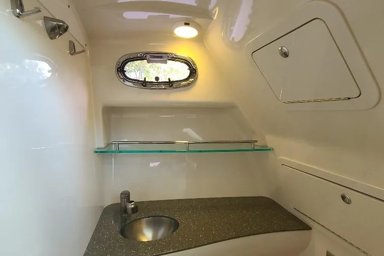 The Snapper Slapper Yacht Photos Pics 2014 Boston Whaler 315 Conquest Pilothouse interior with sink and porthole window.