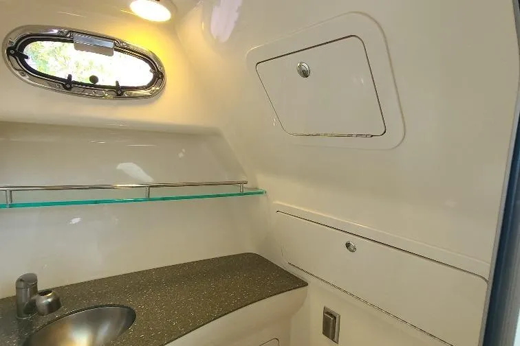 The Snapper Slapper Yacht Photos Pics 2014 Boston Whaler 315 Conquest Pilothouse bathroom interior with sink and storage.