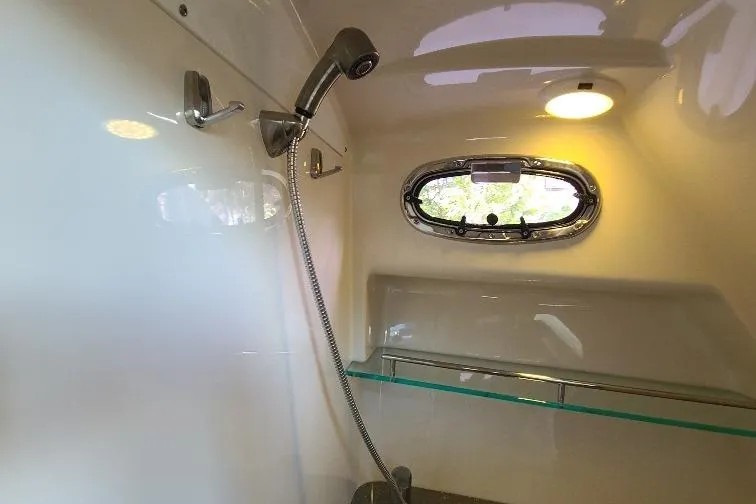 The Snapper Slapper Yacht Photos Pics Interior shower of 2014 Boston Whaler 315 Conquest Pilothouse with window and modern fixtures.