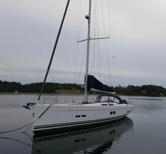 Red's Goose Yacht Photos Pics 2016 Hanse 575 sailboat anchored on calm water, overcast sky.