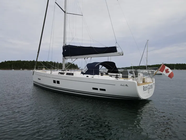 Red's Goose Yacht Photos Pics 2016 Hanse 575 sailboat with Canadian flag, anchored in calm waters.