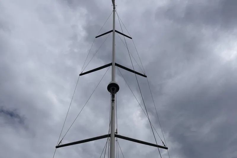 Red's Goose Yacht Photos Pics Mast of 2016 Hanse 575 sailboat against cloudy sky.