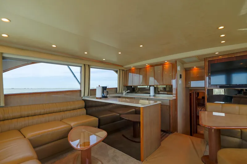 Beer-a-cuda Yacht Photos Pics Luxurious interior of 2005 Viking 48 Convertible yacht with modern furnishings and panoramic windows.