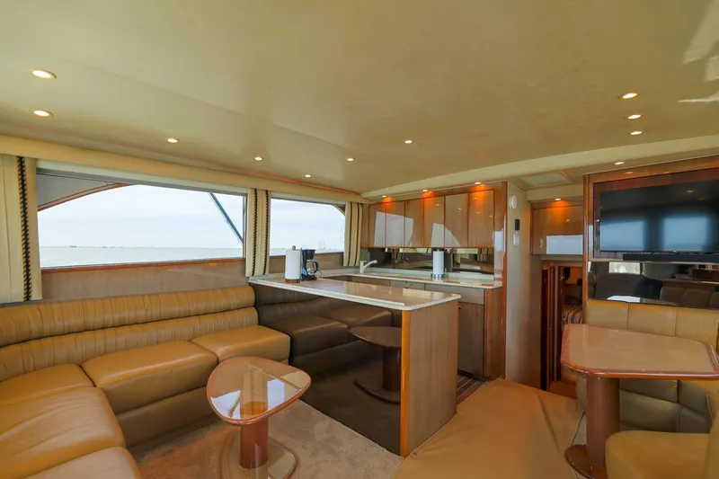 Beer-a-cuda Yacht Photos Pics Luxurious interior of 2005 Viking 48 Convertible yacht with modern kitchen and seating area.
