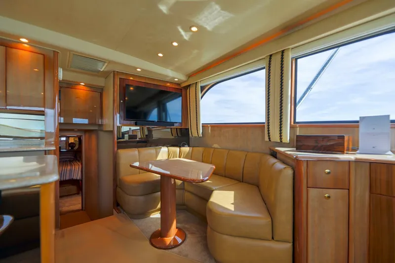 Beer-a-cuda Yacht Photos Pics Luxurious interior of 2005 Viking 48 Convertible yacht with elegant seating and wood finishes.