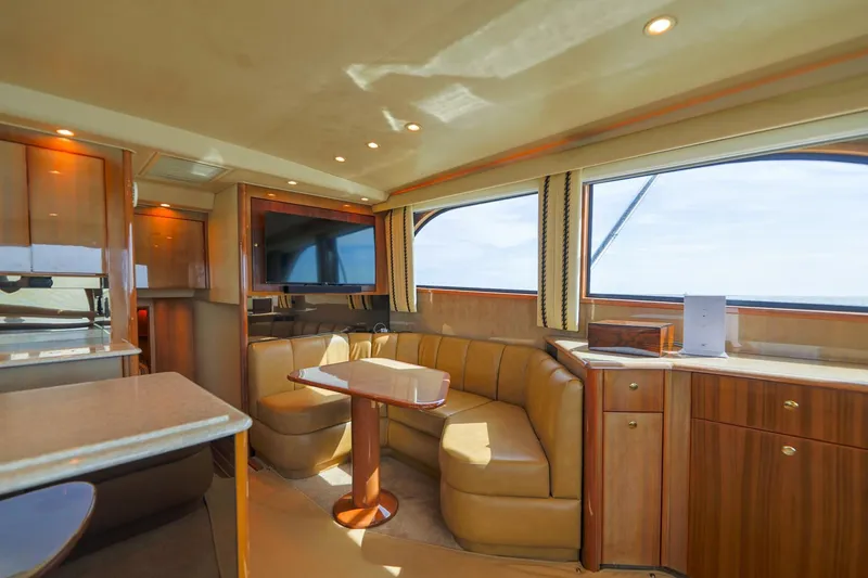 Beer-a-cuda Yacht Photos Pics Luxurious interior of 2005 Viking 48 Convertible yacht with leather seating and wood finishes.
