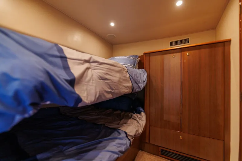 Beer-a-cuda Yacht Photos Pics Bunk beds in 2005 Viking 48 Convertible yacht cabin with wooden wardrobe.