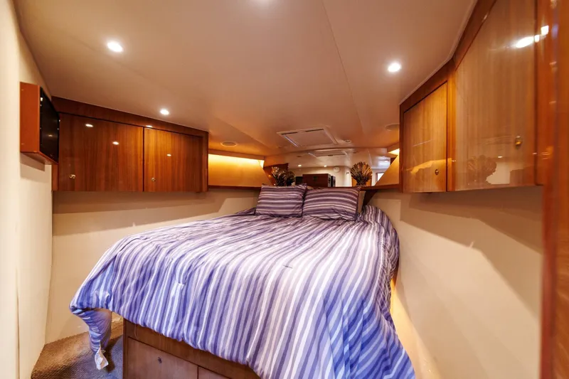 Beer-a-cuda Yacht Photos Pics Luxurious cabin interior of 2005 Viking 48 Convertible yacht with striped bedding.