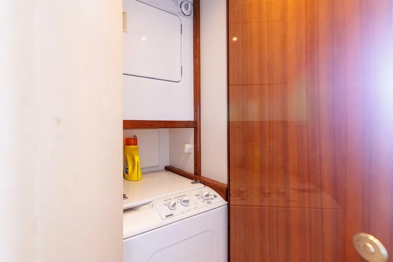 Beer-a-cuda Yacht Photos Pics Laundry area with washer and dryer in 2005 Viking 48 Convertible yacht.