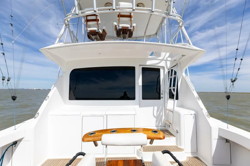 Beer-a-cuda Yacht Photos Pics 2005 Viking 48 Convertible yacht, rear view, fishing setup, ocean backdrop.