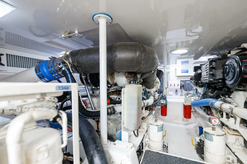 Beer-a-cuda Yacht Photos Pics Engine room of 2005 Viking 48 Convertible yacht, showcasing machinery and components.