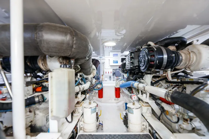 Beer-a-cuda Yacht Photos Pics Engine room of 2005 Viking 48 Convertible yacht, showcasing machinery and components.