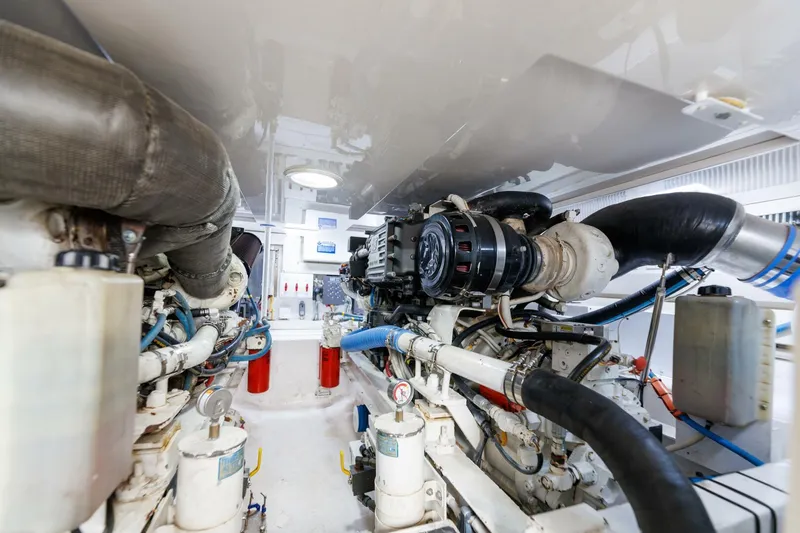 Beer-a-cuda Yacht Photos Pics Engine room of 2005 Viking 48 Convertible yacht, showcasing machinery and components.