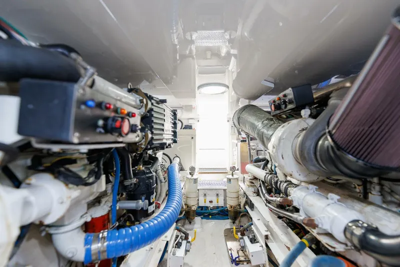 Beer-a-cuda Yacht Photos Pics Engine room of 2005 Viking 48 Convertible yacht, showcasing mechanical components and systems.