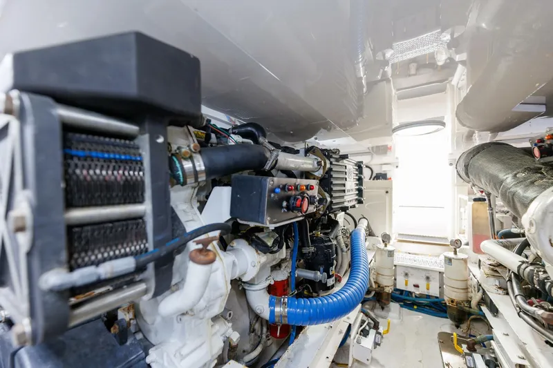 Beer-a-cuda Yacht Photos Pics Engine room of 2005 Viking 48 Convertible yacht, showcasing mechanical components and systems.