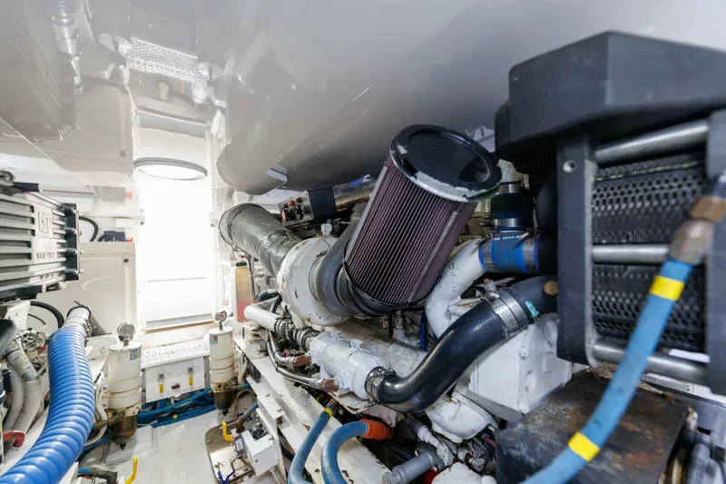 Beer-a-cuda Yacht Photos Pics Engine room of 2005 Viking 48 Convertible yacht, showcasing mechanical components and systems.