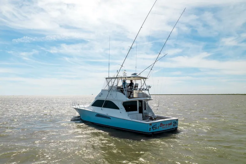 Beer-a-cuda Yacht Photos Pics 2005 Viking 48 Convertible yacht on open water under a blue sky.