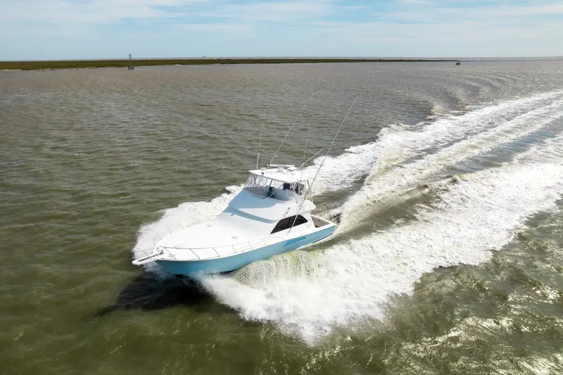 Beer-a-cuda Yacht Photos Pics 2005 Viking 48 Convertible yacht cruising on open water.