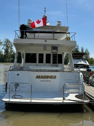 Mariner Yacht Photos Pics 2006 President 63 Pilot House yacht docked, displaying Canadian flag, Vancouver BC.