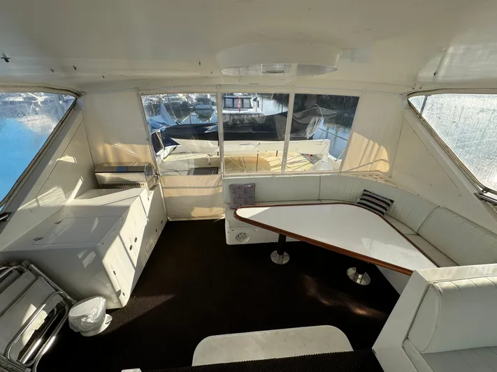 Mariner Yacht Photos Pics 2006 President 63 Pilot House interior with seating and table, featuring large windows.