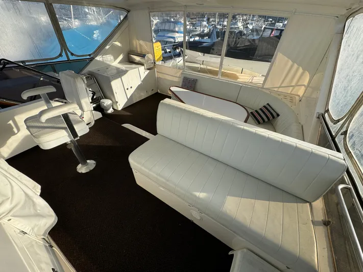 Mariner Yacht Photos Pics Luxurious 2006 President 63 Pilot House interior with white seating and panoramic windows.