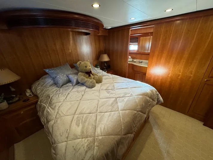 Mariner Yacht Photos Pics Luxurious bedroom in 2006 President 63 Pilot House yacht with plush bedding and wooden interior.