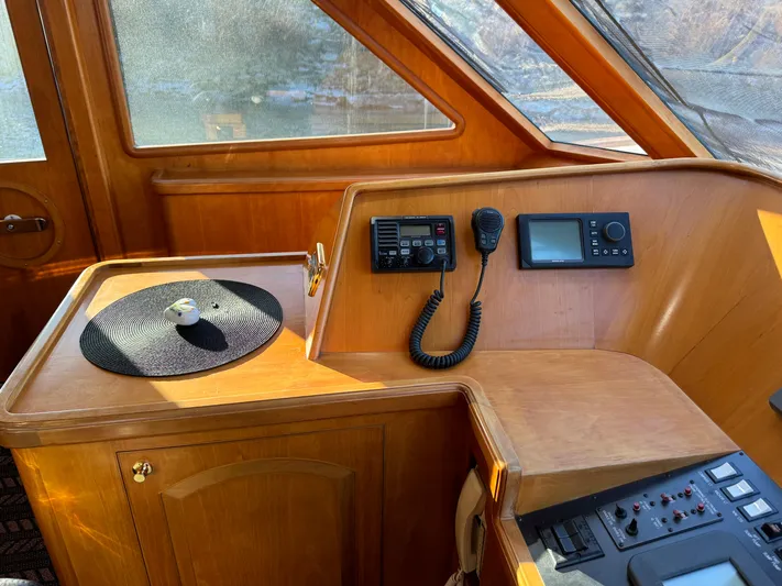 Mariner Yacht Photos Pics 2006 President 63 Pilot House interior with navigation equipment and wooden finish.