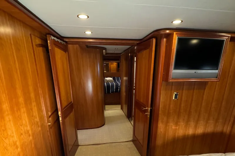 Mariner Yacht Photos Pics Luxurious wooden interior of 2006 President 63 Pilot House yacht with hallway and TV.