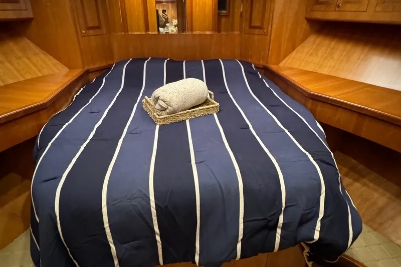 Mariner Yacht Photos Pics Luxurious cabin interior of 2006 President 63 Pilot House yacht with striped bedding.