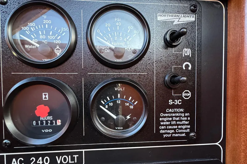 Mariner Yacht Photos Pics Control panel of a 2006 President 63 Pilot House with gauges and caution label.