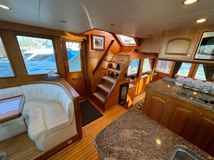 Mariner Yacht Photos Pics Luxurious interior of a 2006 President 63 Pilot House yacht with wood finishes and seating area.
