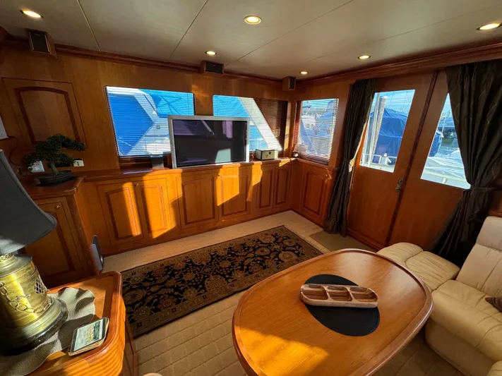 Mariner Yacht Photos Pics Luxurious interior of a 2006 President 63 Pilot House yacht with elegant wood finishes.