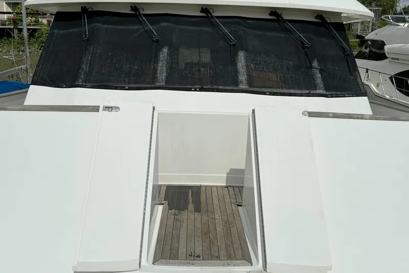 Mariner Yacht Photos Pics 2006 President 63 Pilot House yacht with sleek white deck and tinted windows.