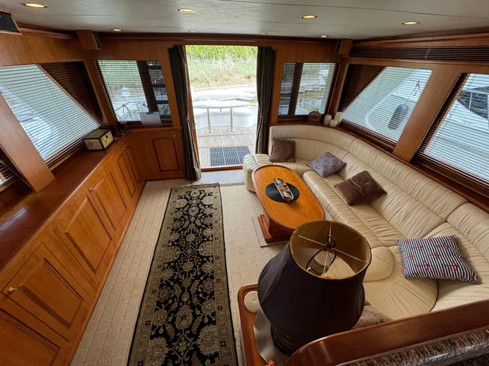 Mariner Yacht Photos Pics Luxurious interior of 2006 President 63 Pilot House yacht with elegant wood finishes and plush seating.