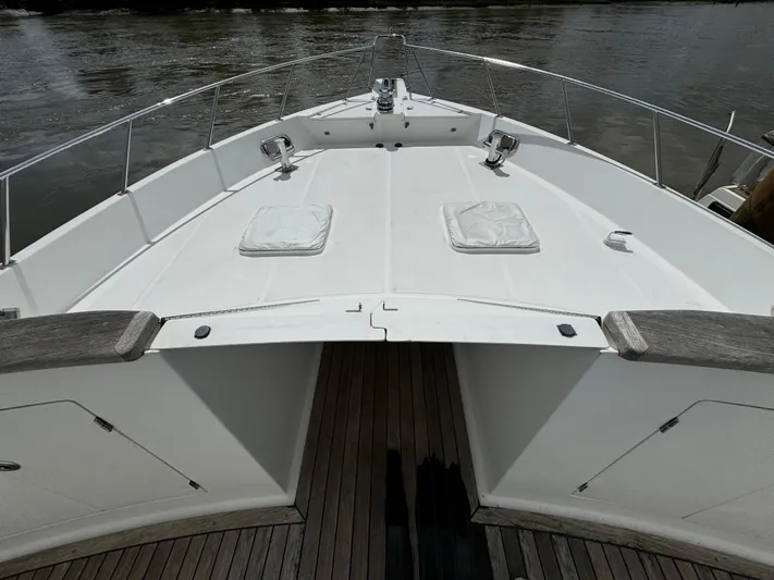 Mariner Yacht Photos Pics 2006 President 63 Pilot House yacht bow with cushioned seating and wooden deck.