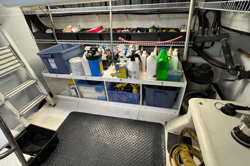 Mariner Yacht Photos Pics Storage area in a 2006 President Legend 630 Pilothouse with cleaning supplies and equipment.