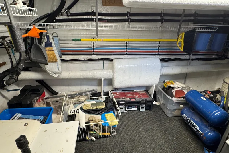 Mariner Yacht Photos Pics Storage area in a 2006 President Legend 630 Pilothouse with tools and cleaning supplies.
