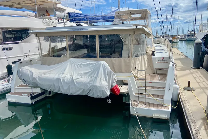  Yacht Photos Pics 2024 Fountaine Pajot Catamaran Aura 51 docked at marina, rear view.