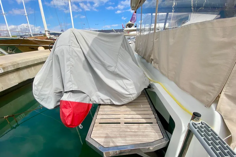  Yacht Photos Pics 2024 Fountaine Pajot Catamaran Aura 51 docked, covered with protective tarp.