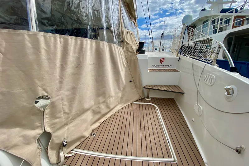 Yacht Photos Pics 2024 Fountaine Pajot Catamaran Aura 51 deck with wood finish and protective cover.