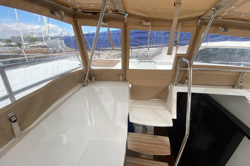  Yacht Photos Pics 2024 Fountaine Pajot Catamaran Aura 51 cockpit with tan canopy and seating area.